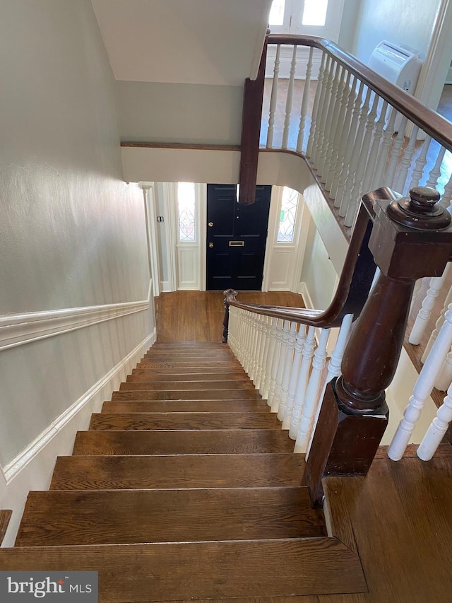 stairs with hardwood / wood-style flooring