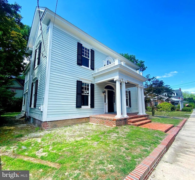 neoclassical home with a front yard