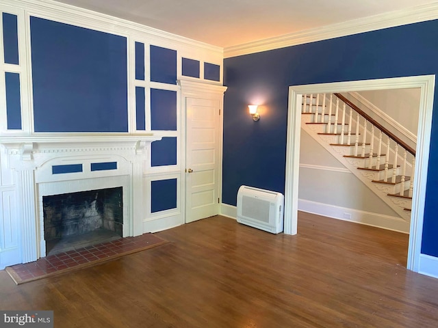 unfurnished living room with crown molding, dark wood-type flooring, and a fireplace