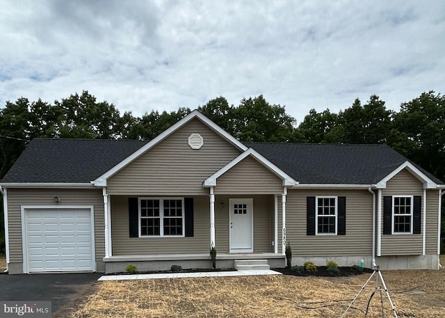 view of front facade featuring covered porch and a garage