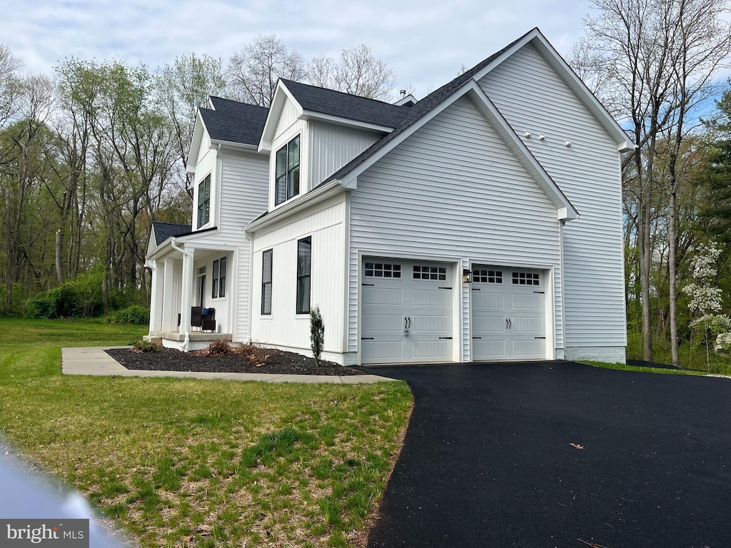 view of home's exterior featuring a garage and a lawn