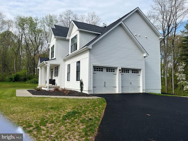 view of home's exterior featuring a garage and a lawn