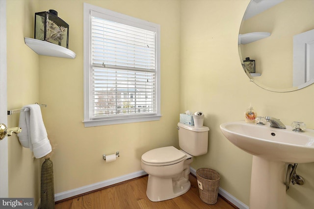 bathroom featuring sink, wood-type flooring, and toilet