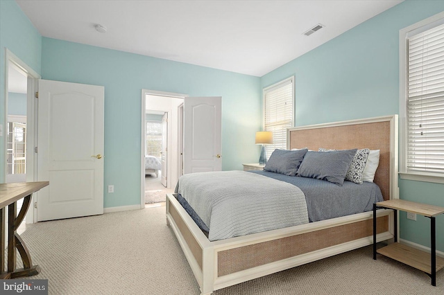 bedroom with lofted ceiling and light carpet