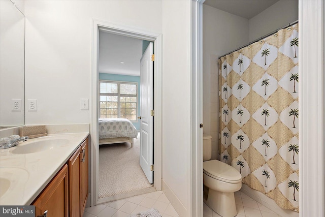 bathroom with vanity, curtained shower, tile patterned floors, and toilet