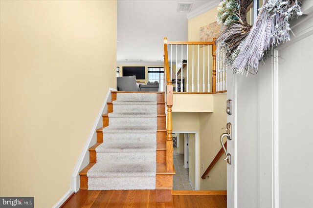 stairway with hardwood / wood-style flooring