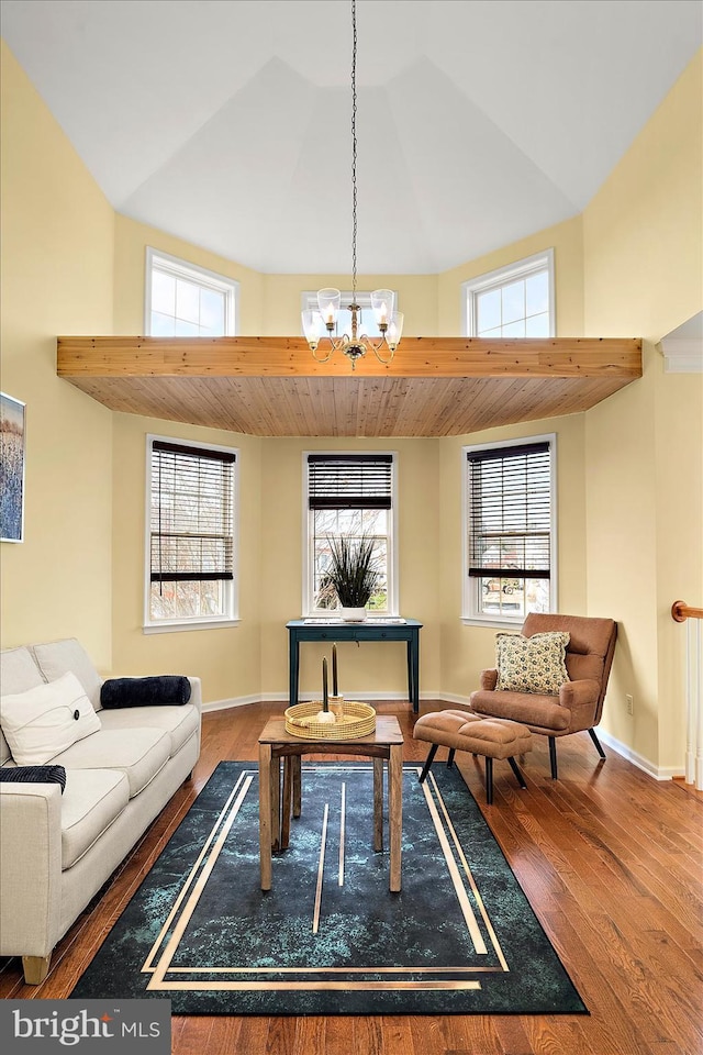 living area featuring a chandelier and hardwood / wood-style floors