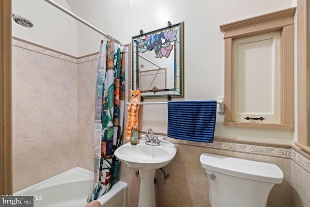 bathroom featuring tile walls, toilet, and shower / tub combo