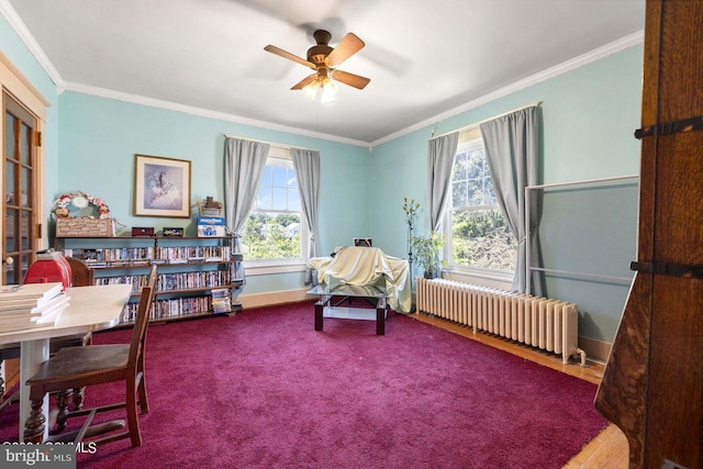 sitting room featuring ceiling fan, crown molding, plenty of natural light, and radiator heating unit