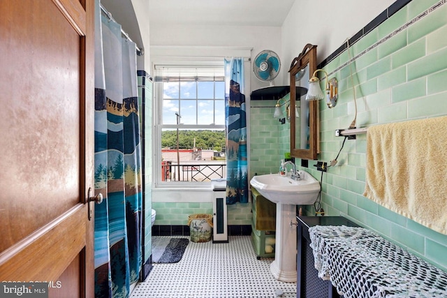 bathroom with tile walls