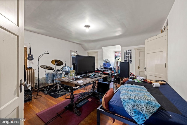 office featuring lofted ceiling and hardwood / wood-style floors