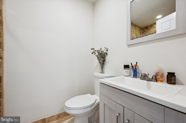 bathroom featuring toilet and vanity