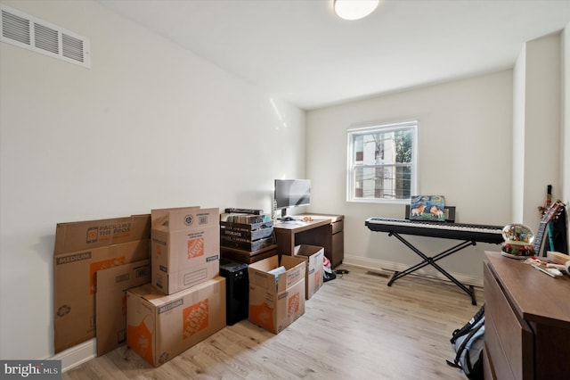 office with light hardwood / wood-style flooring