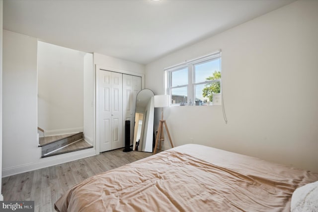 bedroom featuring a closet and light hardwood / wood-style flooring