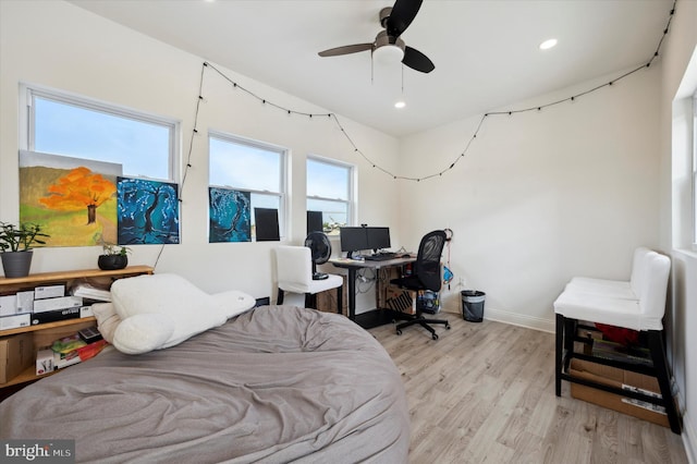 bedroom with ceiling fan and light hardwood / wood-style floors