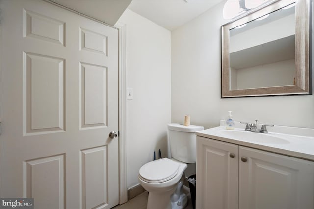 bathroom featuring toilet and vanity