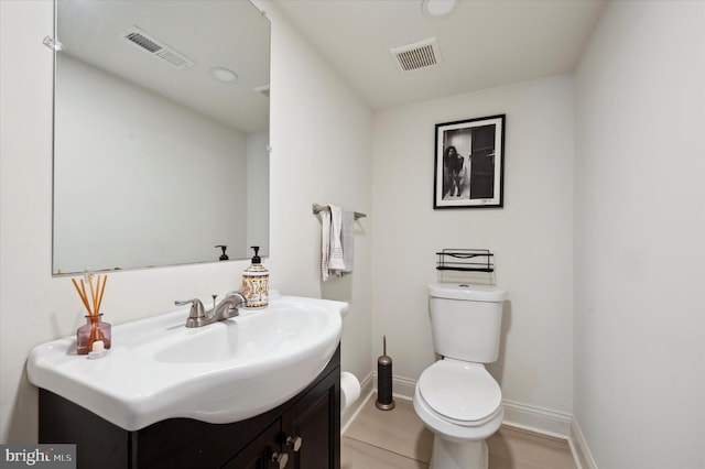 bathroom featuring toilet and vanity