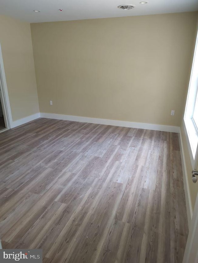 empty room with hardwood / wood-style flooring