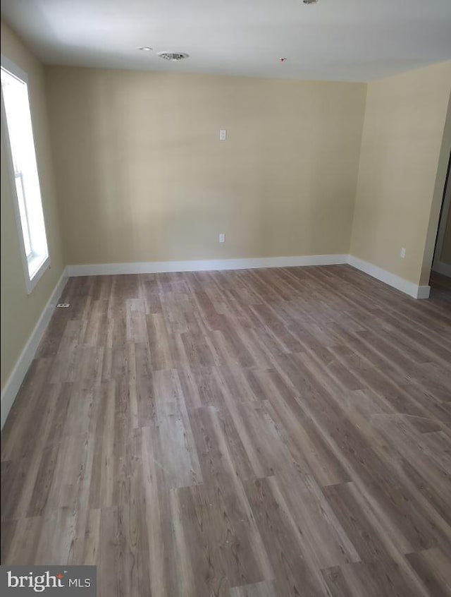 unfurnished room with hardwood / wood-style flooring