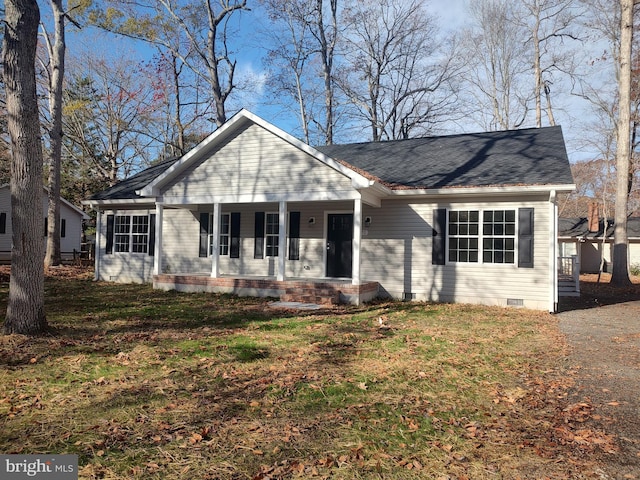 ranch-style home with covered porch and a front yard