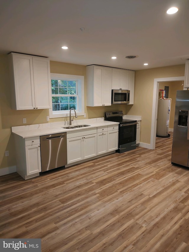 kitchen featuring white cabinets, sink, and appliances with stainless steel finishes