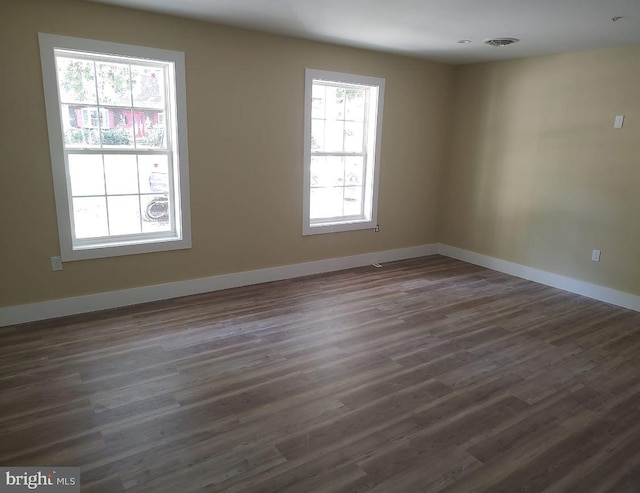 unfurnished room with dark hardwood / wood-style floors