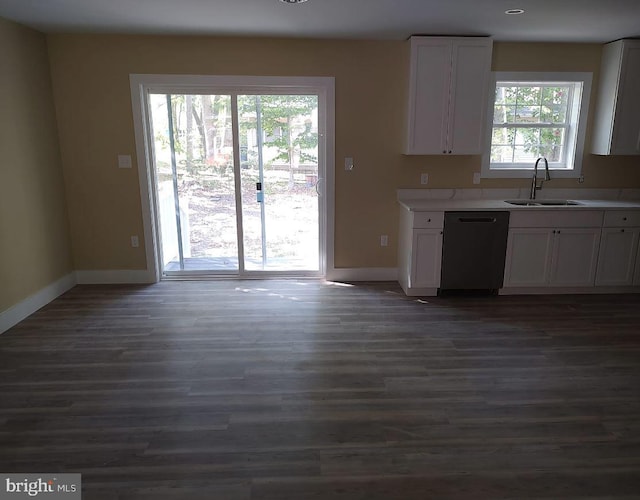 kitchen featuring white cabinets, black dishwasher, dark wood-type flooring, and sink