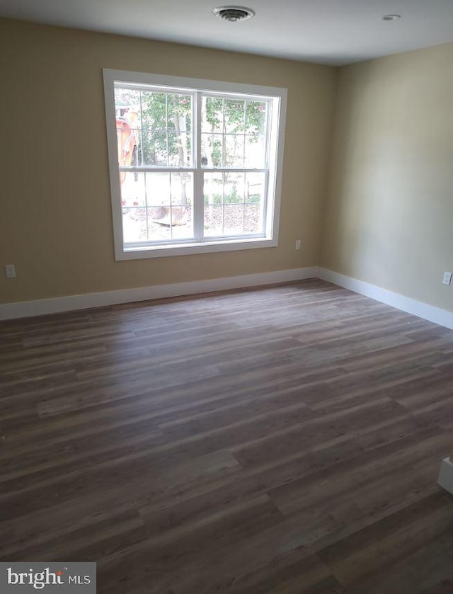 empty room with dark wood-type flooring