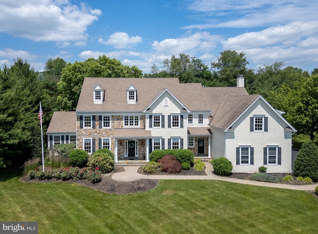 colonial inspired home with a front lawn