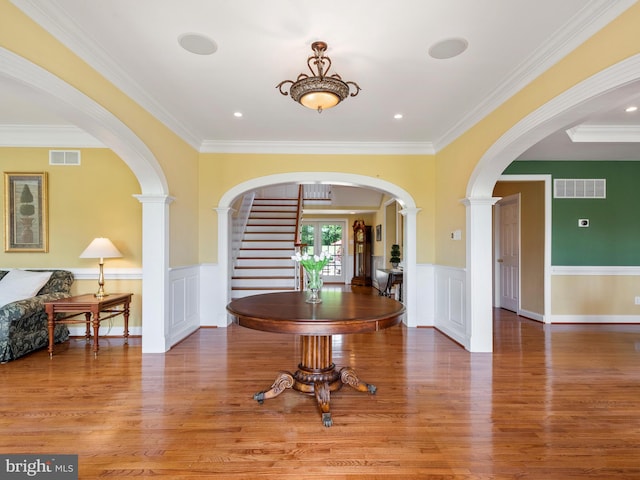 foyer with hardwood / wood-style flooring and crown molding