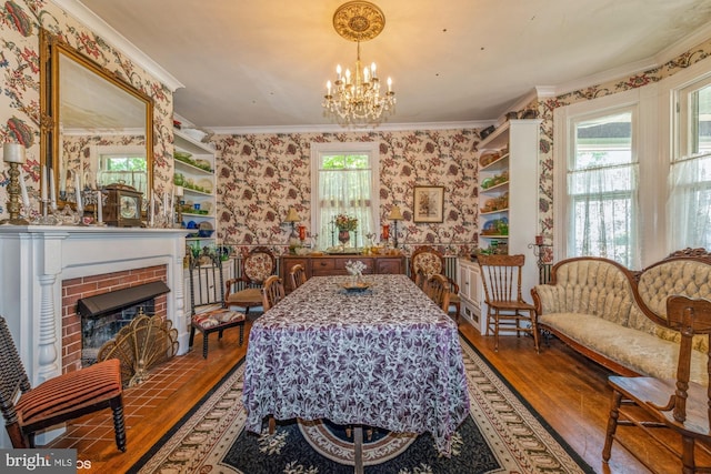 interior space with a fireplace, hardwood / wood-style flooring, plenty of natural light, and a notable chandelier