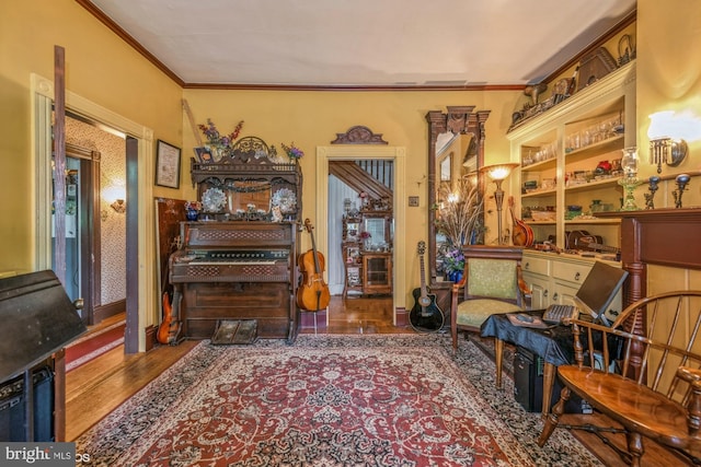 living area featuring dark hardwood / wood-style flooring and ornamental molding