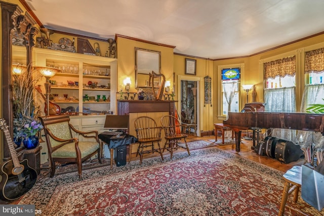 living area with crown molding and wood-type flooring