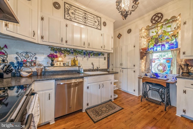 kitchen featuring stainless steel appliances, white cabinetry, and sink