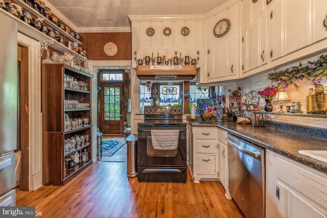 kitchen featuring ventilation hood, white cabinets, stainless steel dishwasher, and black range with electric cooktop