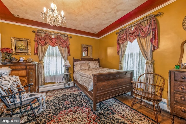 bedroom with a baseboard heating unit, crown molding, multiple windows, and an inviting chandelier