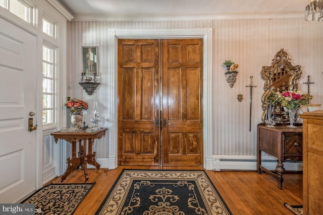 entrance foyer with light hardwood / wood-style floors and crown molding