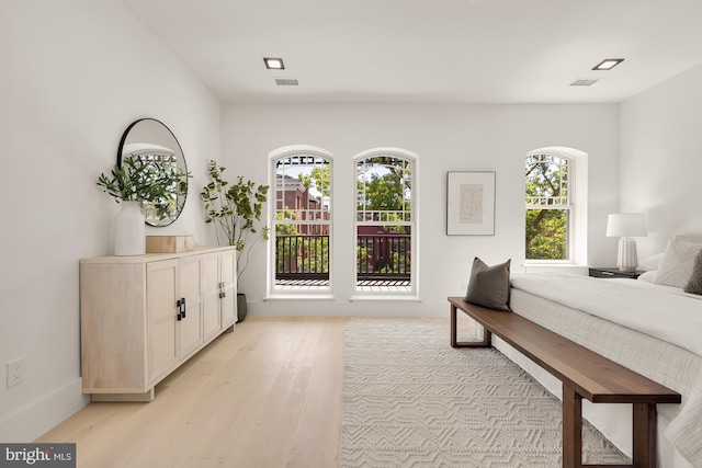 bedroom featuring light wood-type flooring and multiple windows