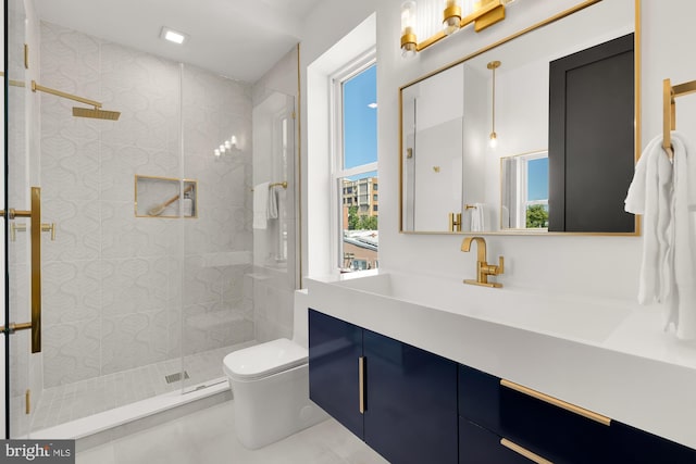 bathroom with an enclosed shower, vanity, and toilet