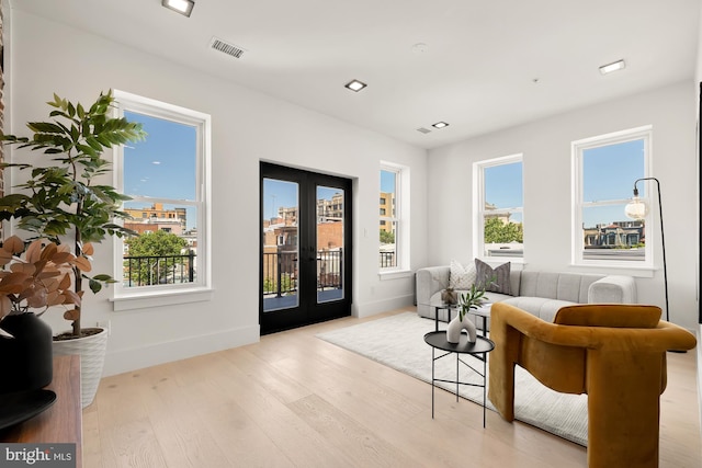 sitting room featuring french doors and light wood-type flooring