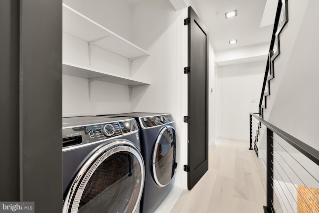 laundry area featuring light hardwood / wood-style flooring and independent washer and dryer