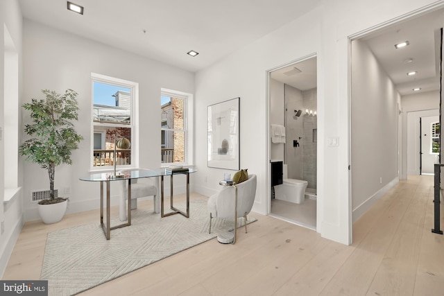 bathroom featuring hardwood / wood-style floors, toilet, and a shower with shower door