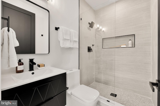 bathroom with vanity, a shower with shower door, and toilet