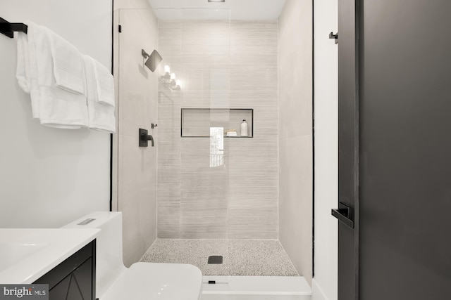 bathroom with toilet, an enclosed shower, and vanity