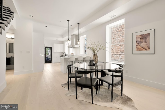 dining room featuring light hardwood / wood-style floors and sink