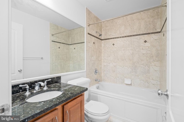 full bathroom featuring tiled shower / bath combo, toilet, and vanity