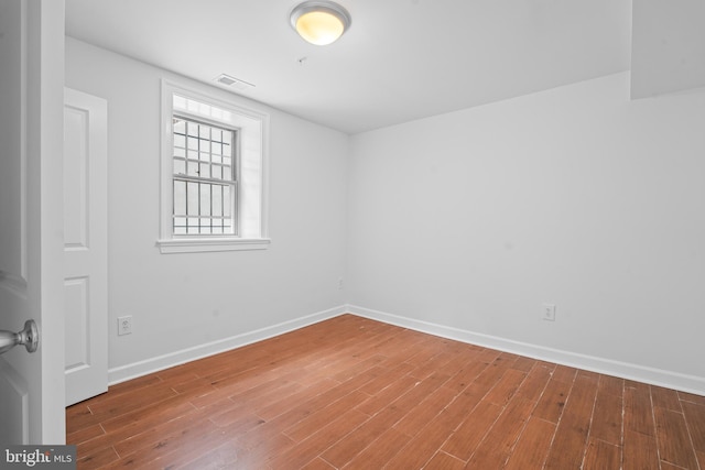 unfurnished room with hardwood / wood-style floors