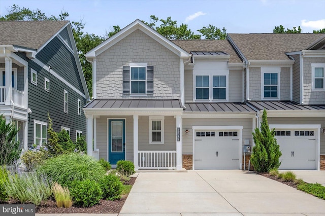 view of property featuring a porch and a garage