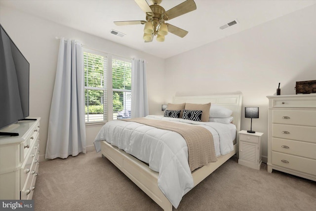 bedroom featuring light carpet, visible vents, and a ceiling fan