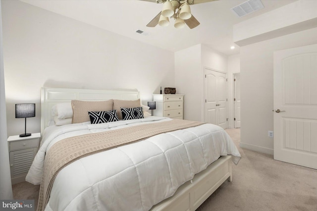 bedroom with light carpet, visible vents, baseboards, a ceiling fan, and a closet